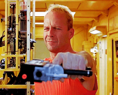 Korben Dallas in the film The Fifth Element pointing a gun and laughing